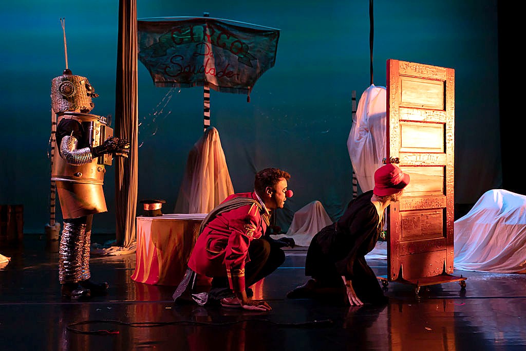 A hand-built animatronic robot costume on stage among painted set pieces